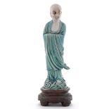 Part biscuit and turquoise glaze figure of an immortal,