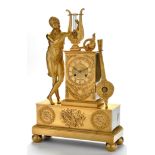 *An Empire gilt bronze mantel clock, with roman dial,