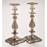 A pair of EP mid 19th Century Old Sheffield candlesticks, campana nozzles, foliate baluster stems,