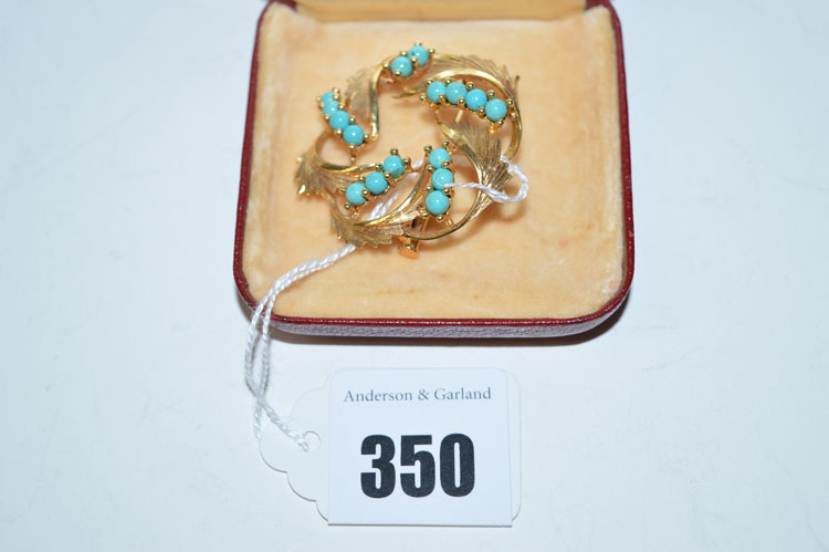 A turquoise and yellow metal wreath pattern brooch, stamped '18k.' to clasp.