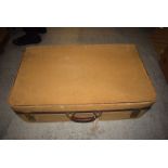 A vintage leather trimmed suitcase.