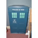 A set of shelves in the form of a Tardis, the doors opening to reveal four shelves.