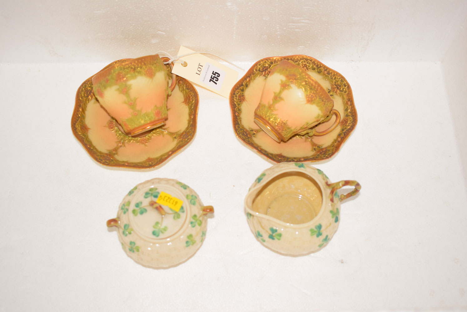 A pair of early 20th Century Royal Worcester specimen teacups and saucers, pattern no.