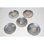 A set of five white metal dishes, embossed with bamboo edges and coin pattern centres.