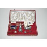 A three-piece silver condiment set, by Francis Hall, Sheffield, in fitted case.