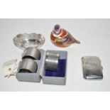 A pair of silver napkin rings; another napkin ring; a small silver cigarette box;