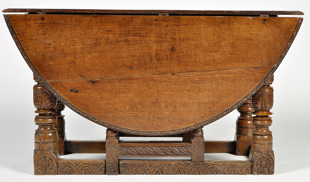 An 18th Century and later, carved oak drop leaf dining table,