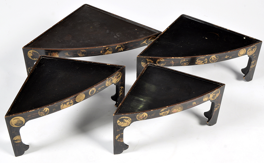 An early 20th Century nest of four Japanese lacquered corner display stands,