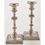 A pair of candlesticks in the mid 18th Century taste, bearing the stamp of Wilson & Sharp,