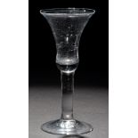 Waisted bell bowl wine glass, raised on a plain stem and conical foot, c.1740, height 16.8cm.