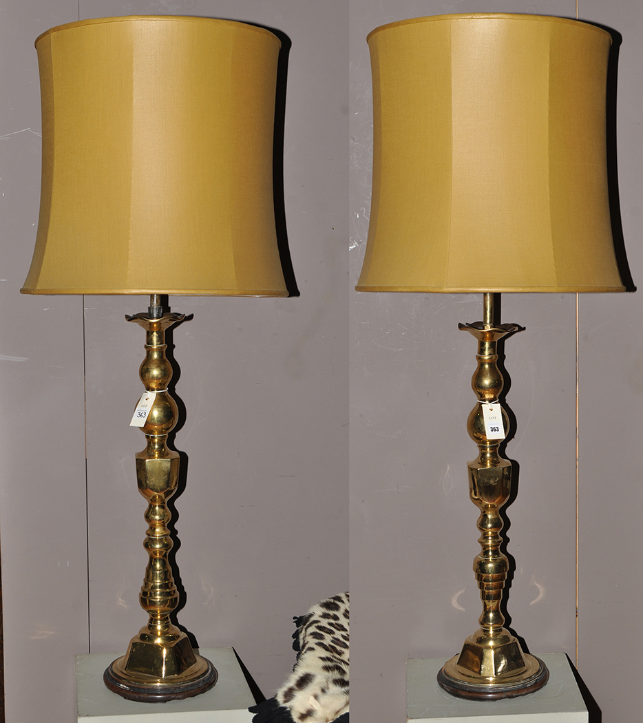 A pair of 18th Century style brass table lamps, of oversized candlestick form,