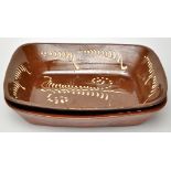 Two Slipware rectangular shaped dishes, decorated with ribbed trails, length 43.5cm approximately.