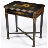 A chinoiserie black lacquer turnover top card table, gilt and painted with figures in a landscape,