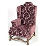 An early 20th Century Jacobean style wing back armchair,