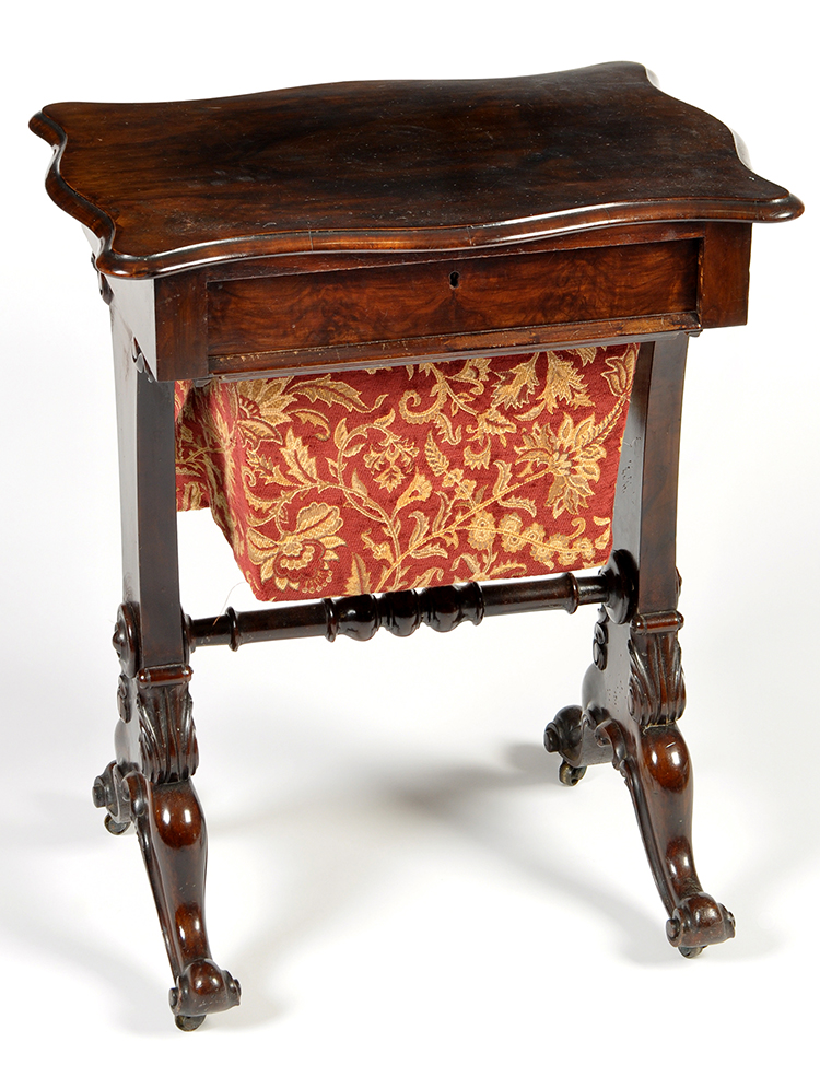 A Victorian walnut work table, the shaped rectangular top above frieze drawer and sliding box under,