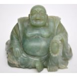 Chinese bowenite carving of a seated Buddha, his left arm resting upon his left knee,