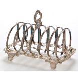 A William IV seven bar toast rack, probably by Joseph Angell I, London 1830, with ornate handle,