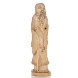 Chinese carved figure of an immortal, wearing long flowing robes,