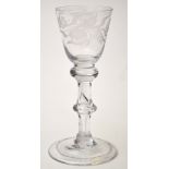 Engraved baluster wine glass, round funnel bowl with flowerheads and foliate meander,