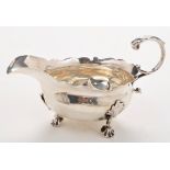 A George II sauce boat, probably by Fuller White, London 1747, oval, leaf capped scroll handle,
