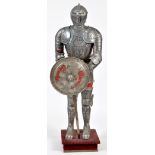 A reproduction German Renaissance style suit of armour, etched with leaf scrolls, busts,