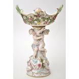 Figural comport after a model by Kandler, with quatre lobed basket having scattered floral sprays,