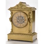 A French gilt bronze mantel clock, the gilt roman dial with pierced floral swag centre,