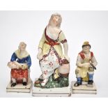 Three Staffordshire pearlware figures, comprising: female figure seated beside a barrel,