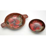 Moorcroft 'Hibiscus' pattern bowl and ashtray, on variegated flambé red ground, lowest length 21.