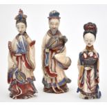 Three Chinese carved painted ivory snuff bottles and stoppers,