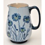 McIntyre pale blue ground "Cornflower" pattern jug, the sides with three floral groups,