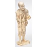 Japanese carved part ivory figure of a river fisherman,