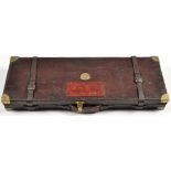 A leather on wood car case for a pair of 12 bore shotguns, fitted for up to 76cms (30in.