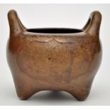 Chinese bronze censer, circular with two loop handles rising from the inturned rim,