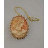 An oval shell cameo brooch of female in