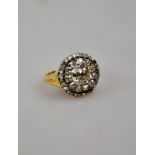 An antique-style diamond cluster ring ha