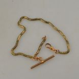 A yellow metal snake style Albert chain