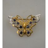 An open work style butterfly brooch, set