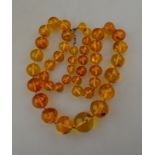 A row of graduated pale amber beads appr