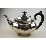 An oval silver teapot with beaded rim an