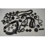 A collection of jet and other black beads including carved jet bead necklace,