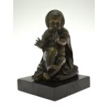 A brown patinated bronze of a putto wearing a cloak (possibly 'Winter' from a Four Seasons set),