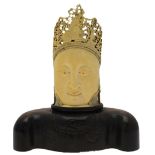 A Chinese ivory tusk carving of the head of Guanyin, 4 character mark to base,