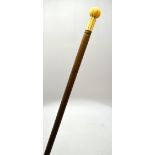 An 18th century ash walking cane, with 8.5 cm reeded ball-and-pillar pommel, 83 cm long overall