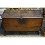 A 17th century six plank elm/oak coffer, the iron hinged top over an iron staple and lock plate,