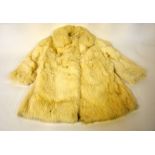 A child's cream rabbit fur coat with satin lining, a 1950s red Chilprufe child's coat,