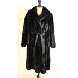 A black faux fur full-length 'Tissavel' lady's coat with wide collar and flared sleeves with tie-