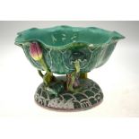 A Chinese green-glazed porcelain bowl of leaf form, on three scroll supports rising from a