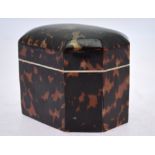 A tortoiseshell tea caddy of elongated octagonal form with bone rim and inner cover, 11 cm wide,