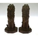 A pair of 19th century seated bronze lions, on cast iron octagonal bases,